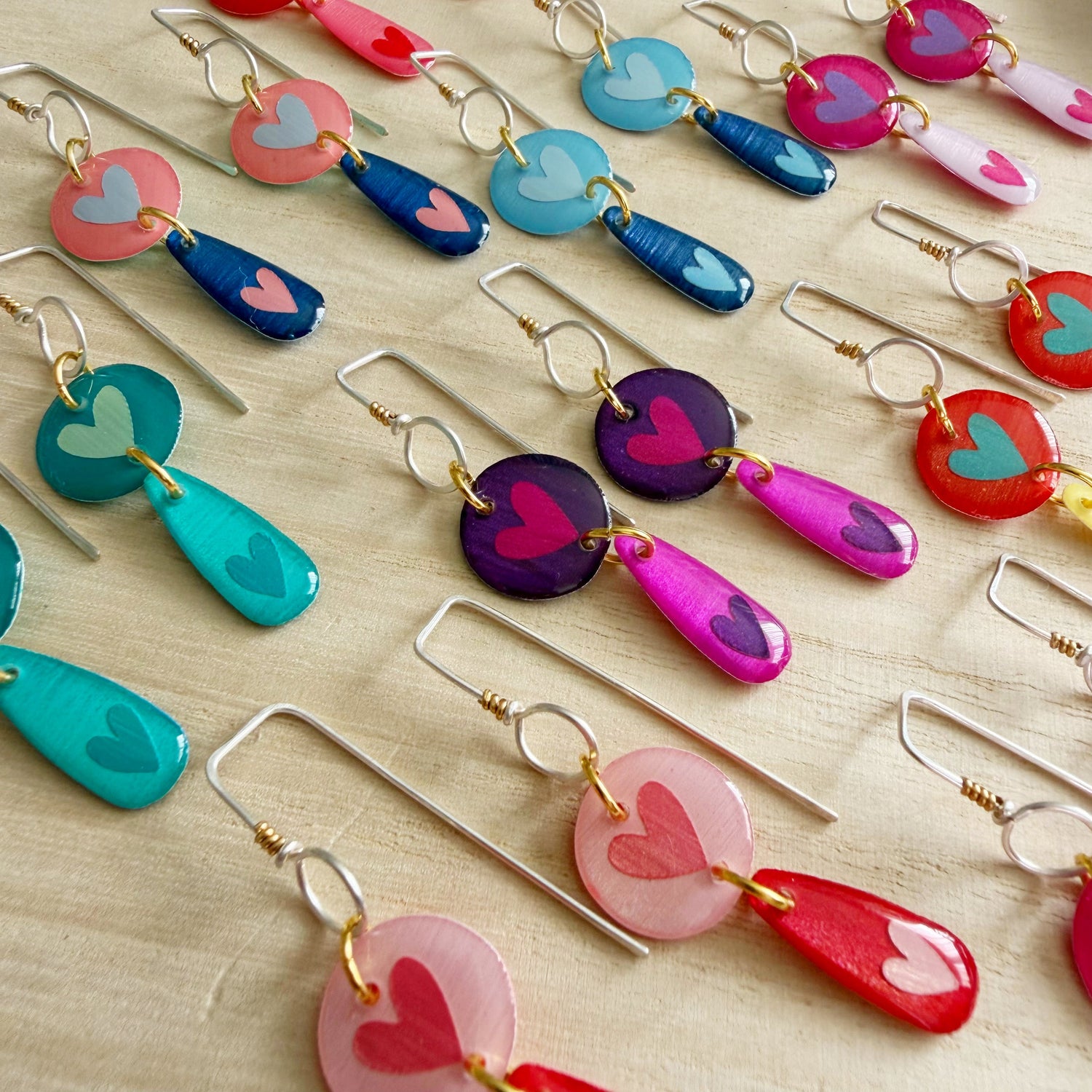 photo of a group of brightly coloured heart dangle handmade earrings