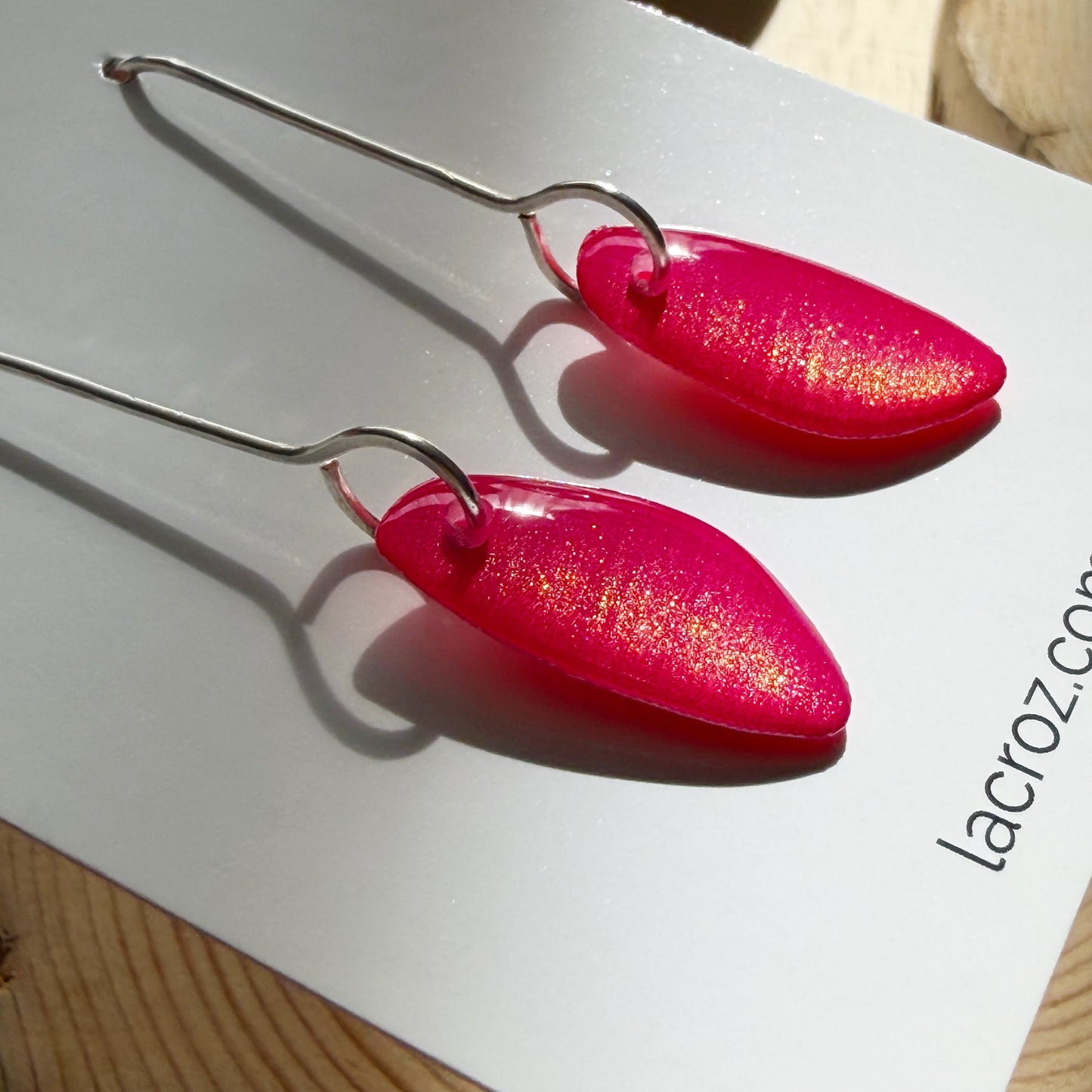 closeup of organic teardrop shaped drop earrings on business card